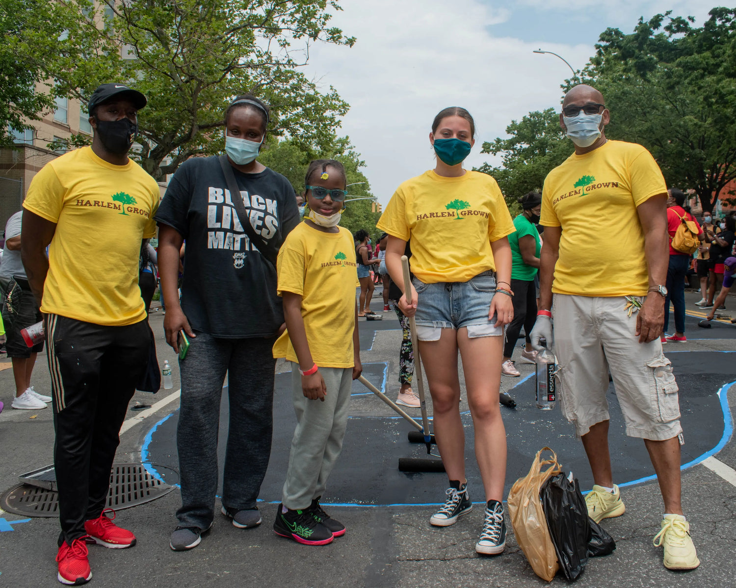 people standing, wearing masks, outside