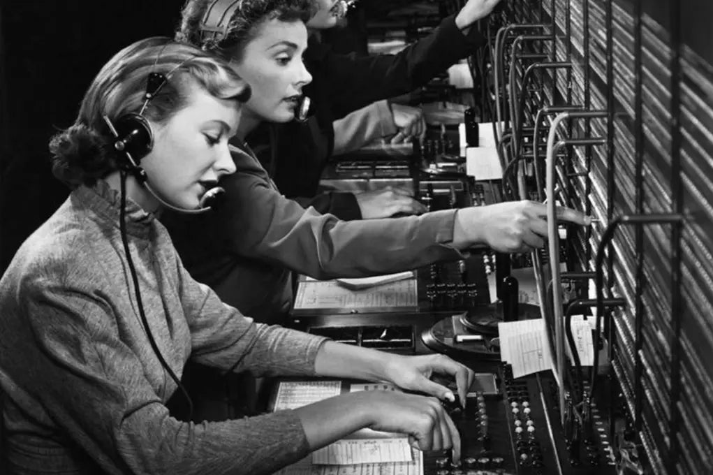 women typing on typewriter