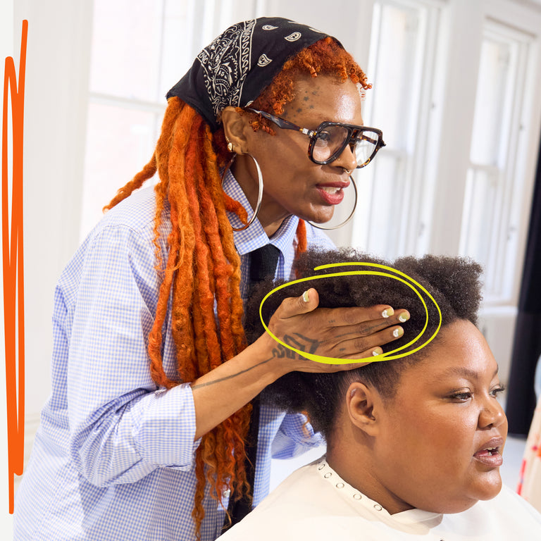 Hairdresser styling a woman's coily hair