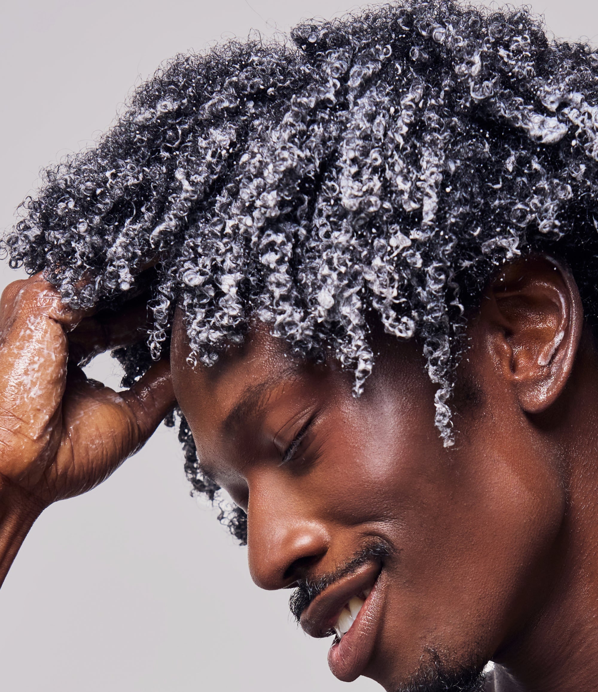 Man with New Wash Rich in his coily hair